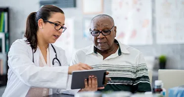 Doctor and patient sharing information on tablet